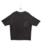 Black t-shirt with a pocket on a hanger against a white background